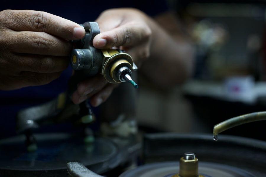 Adjusting the angle at which the stone meets the lap during faceting.
