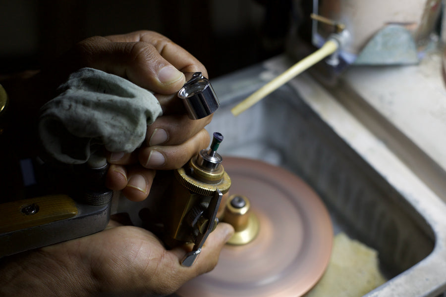 Polishing begins with the table, the flat top facet of the stone. The completed table is visible here.