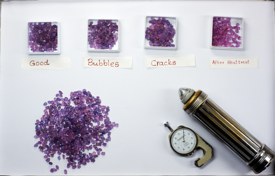 Unheated sapphires sorted into three categories, with a fourth group on the right showing the same stones after heat treatment for comparison.